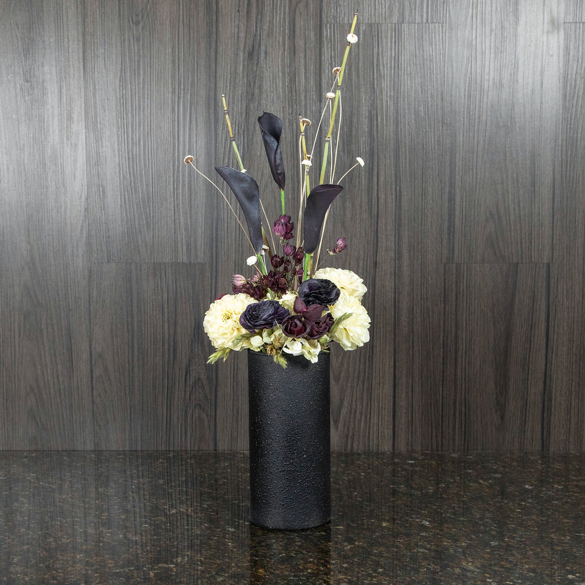 black and white dried flowers in a contemporary black vase