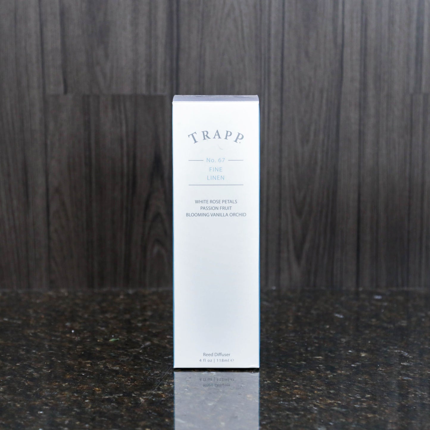 a reed diffuser kit from trapp fragrances in the white box it comes in