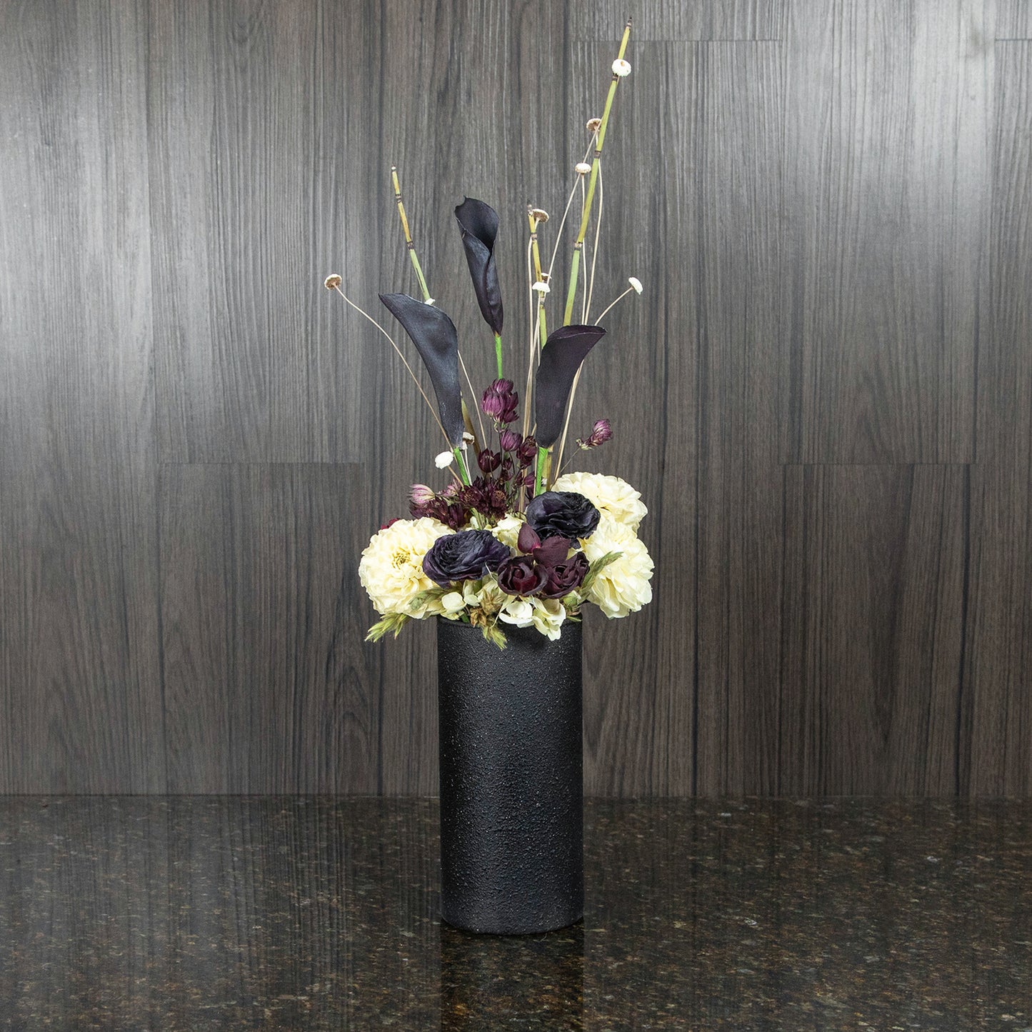 black and white dried flowers in a contemporary black vase