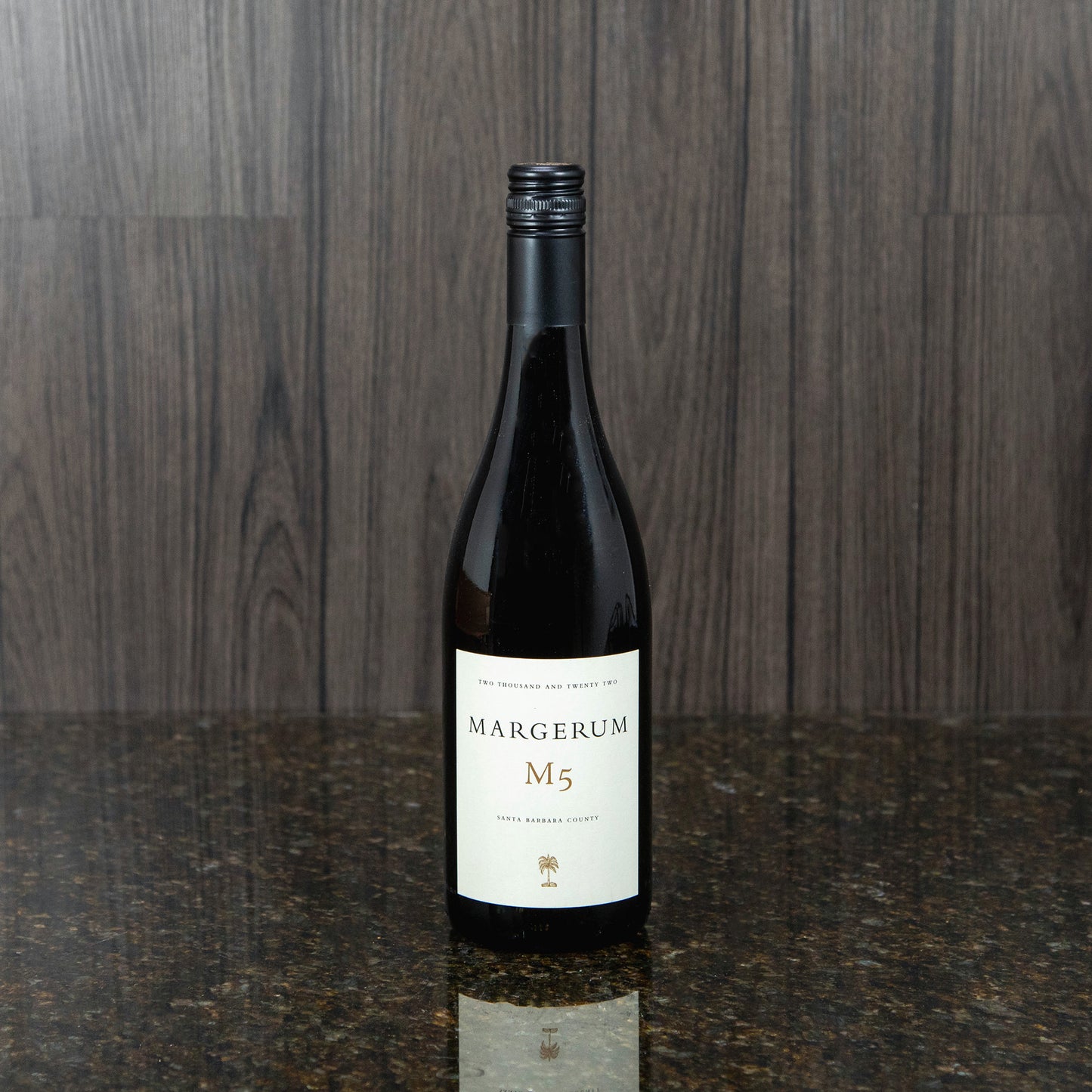 a bottle of a red blend wine with a black bottle and a white label