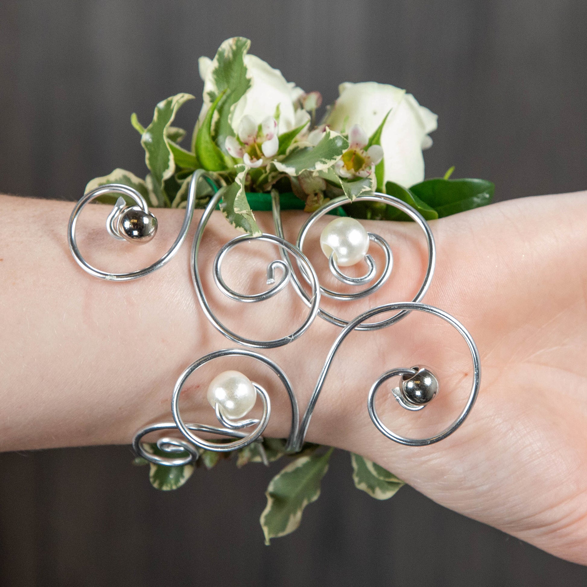 the underside of the wrist corsage showing a curled wire bracelet