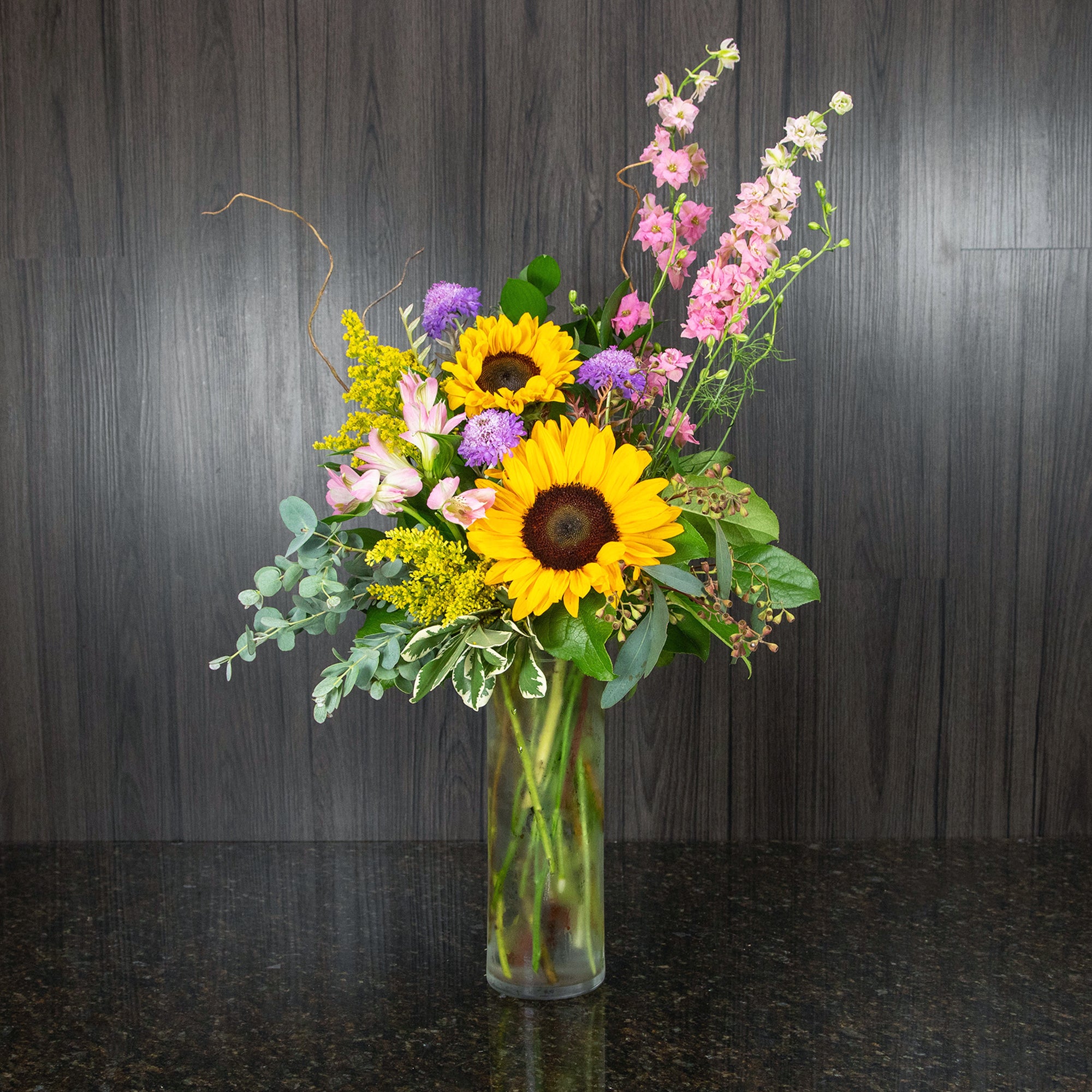 a cheerful summer flower arrangement featuring sunflowers