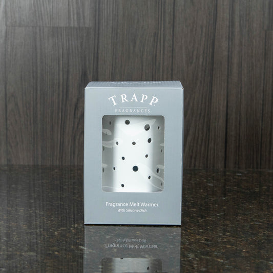 a white electric wax melter in a gray box