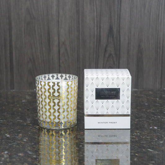 a decorative glass candle votive next to the white box it comes packaged in