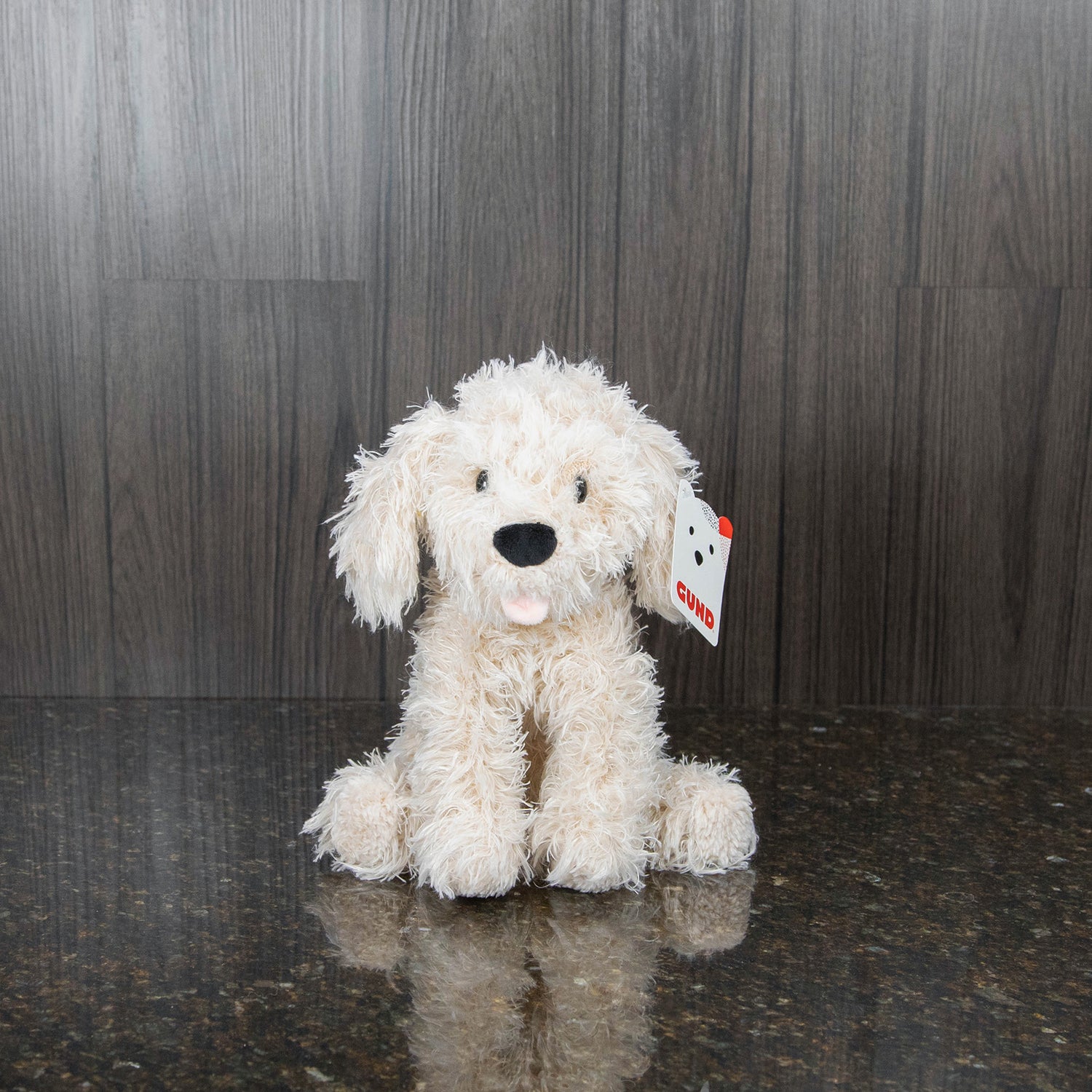 a plush dog with blonde curly fur