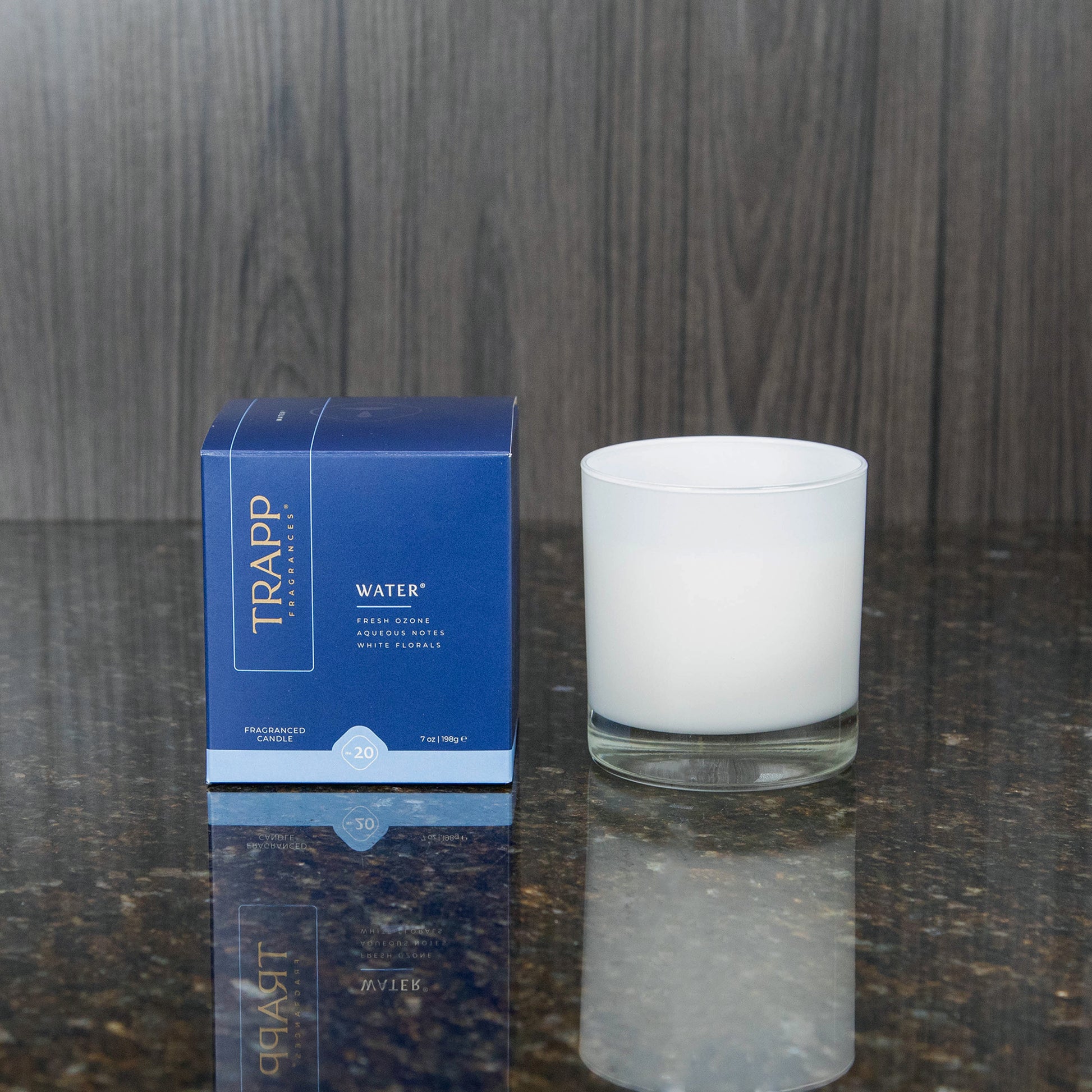 a white candle votive next to the "Water" box