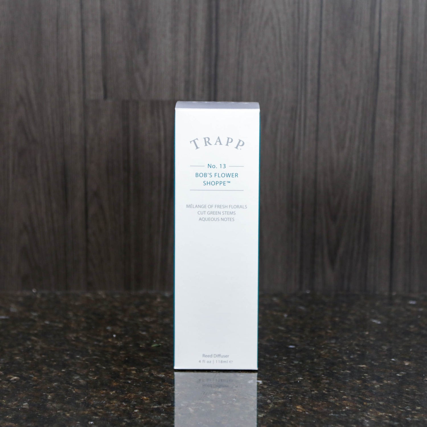 a reed diffuser kit from trapp fragrances in the white box it comes in