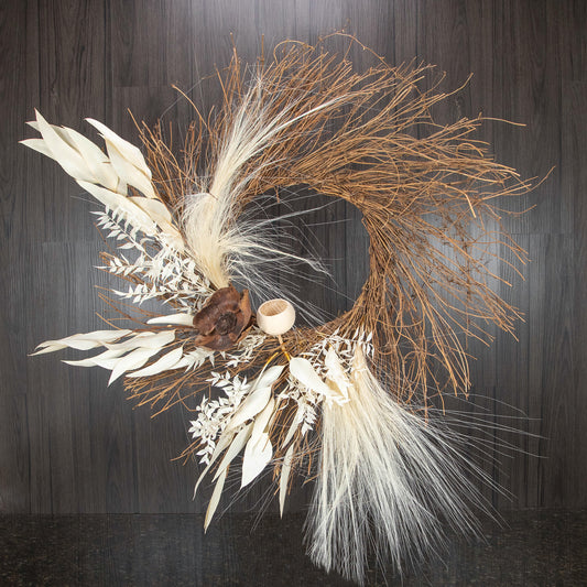 a large and wild wreath made out of dried florals and botanicals